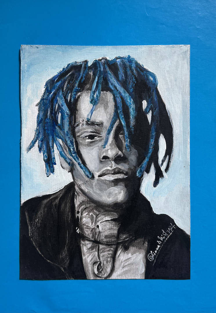 portrait of XXXTentacion with blue dreadlocks and visible elephant tattoo on neck