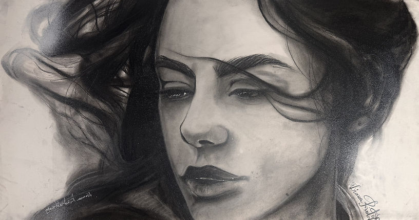 charcoal portrait of a woman with intense gaze and flowing hair