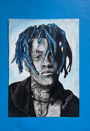 portrait of XXXTentacion with blue dreadlocks and visible elephant tattoo on neck