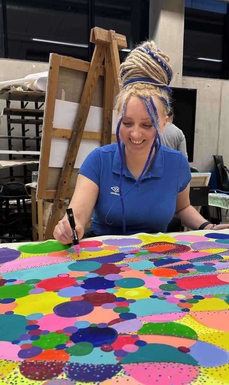 Artist Diana Andriot painting her large-scale acrylic artwork 'The Secret of the Sixth Finger' in a studio for Estonian Academy of Arts exhibition.